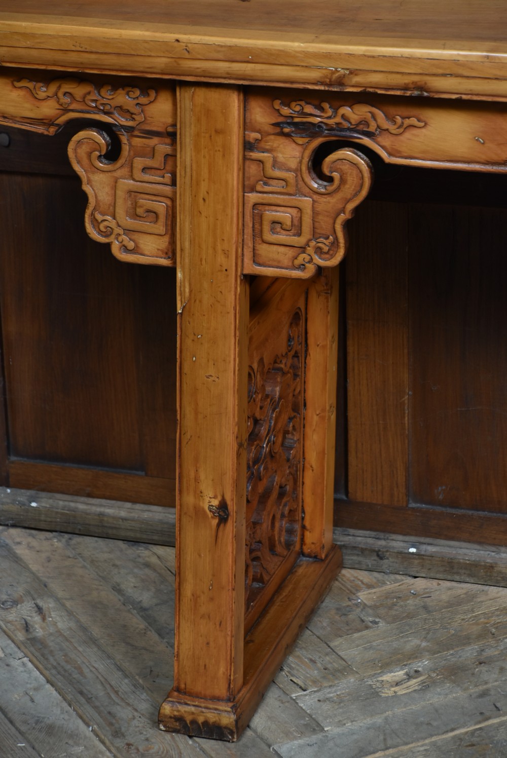 A long, light honey brown timber Chinese altar console table featuring upturned flange ends and carved decorative spandrels. View V