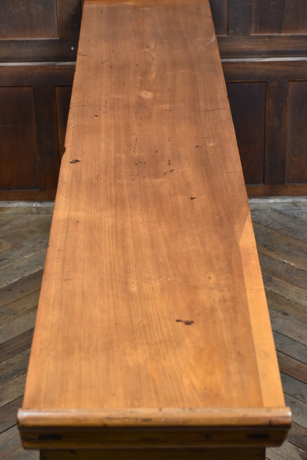 A long, light honey brown timber Chinese altar console table featuring upturned flange ends and carved decorative spandrels. View X
