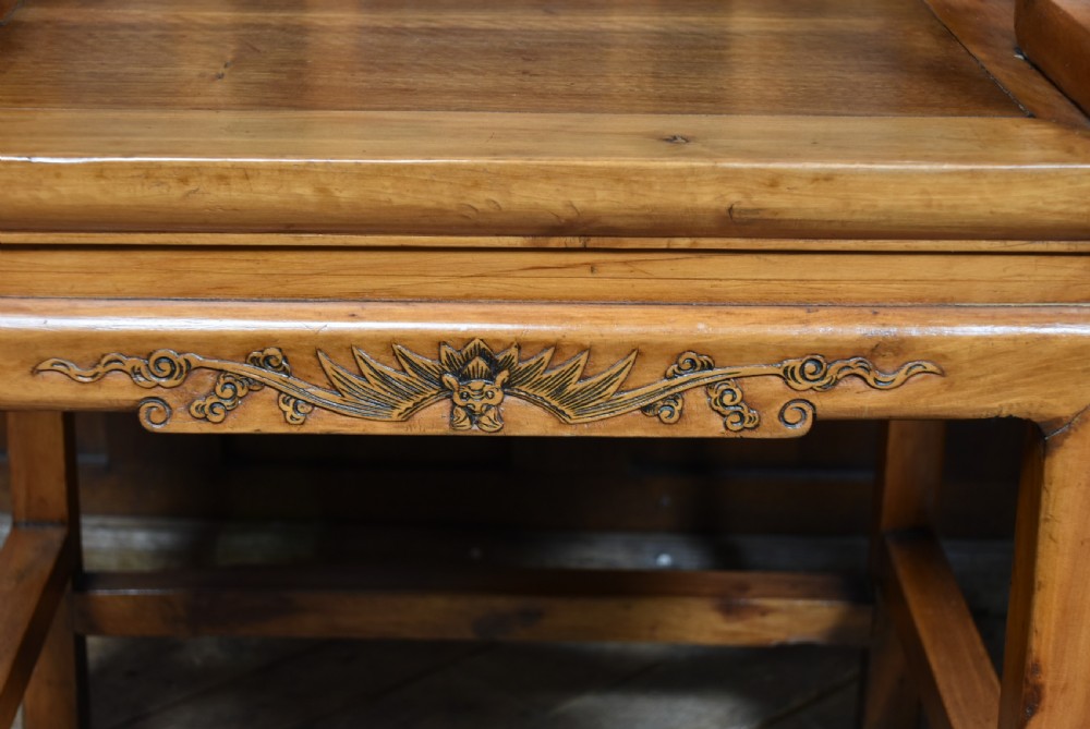 A pair of carved Chinese hardwood armchairs featuring decorative splats with darker wood relief panels and openwork arms. View VIII