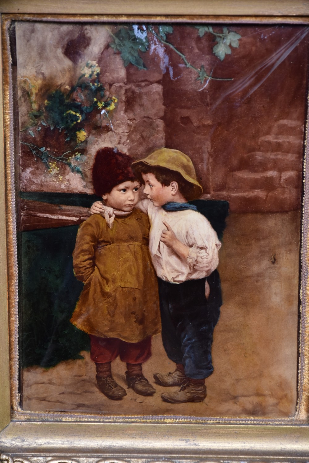 A pair of Victorian glass crystoleum artworks depicting children in countryside scenes, set inside heavy gilded frames. View V