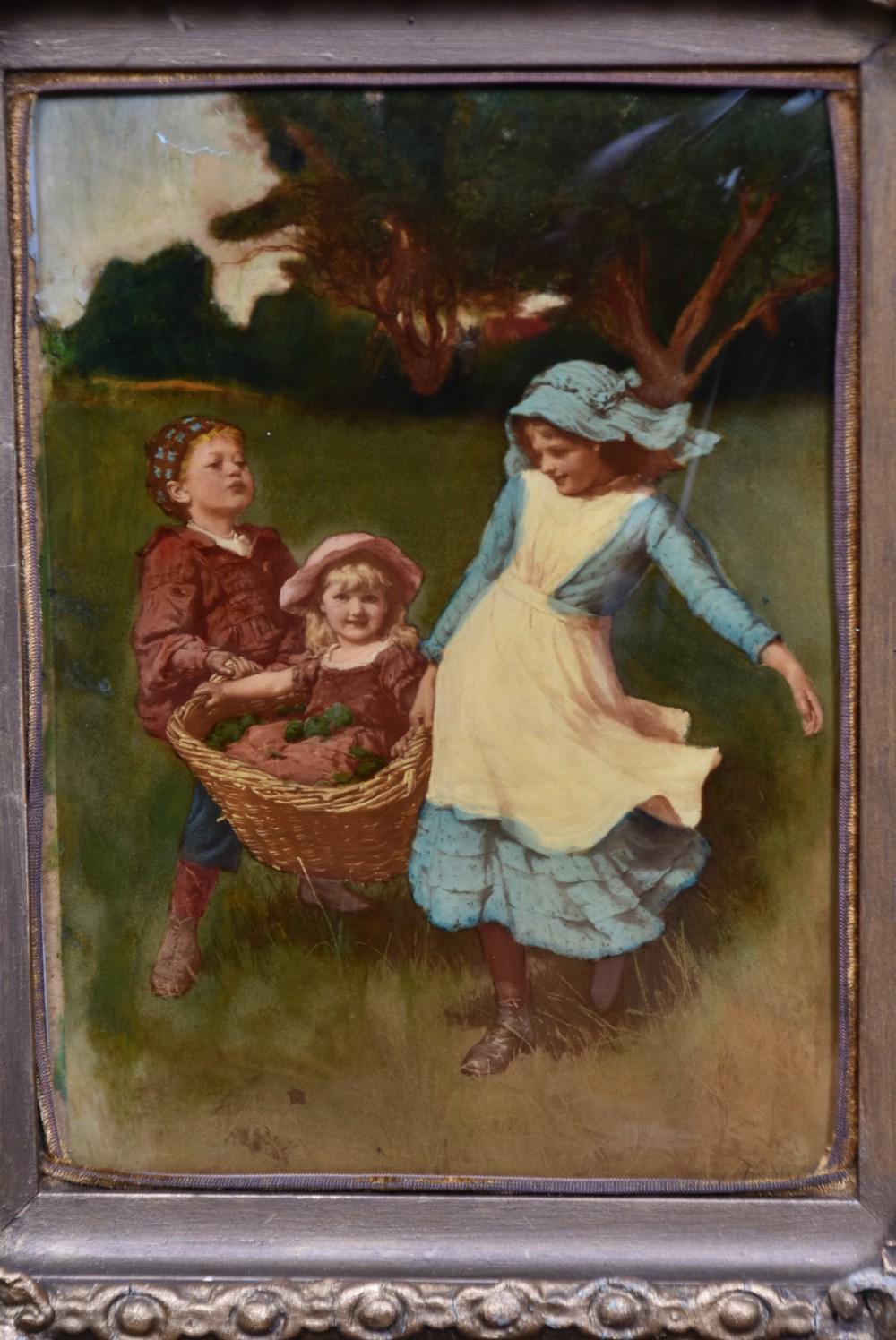 A pair of Victorian glass crystoleum artworks depicting children in countryside scenes, set inside heavy gilded frames. View VI