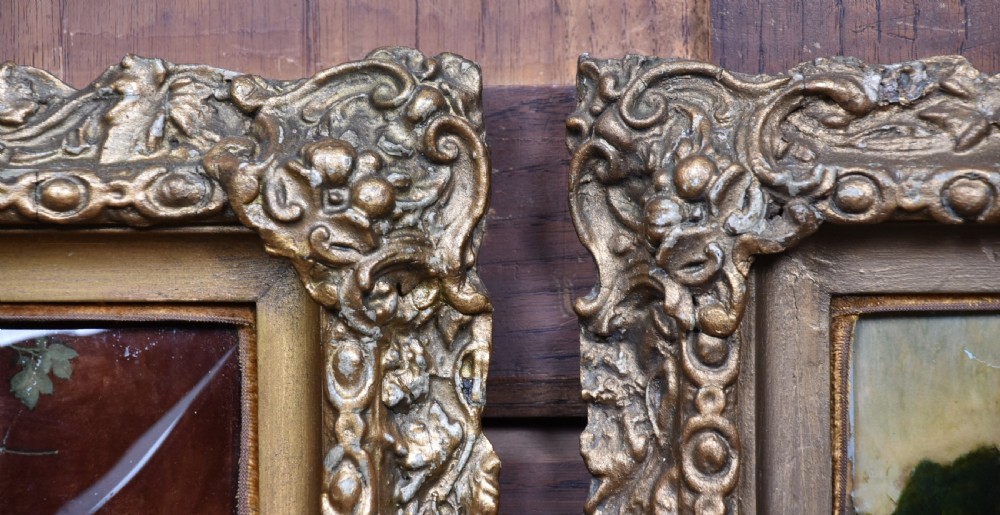 A pair of Victorian glass crystoleum artworks depicting children in countryside scenes, set inside heavy gilded frames. View VII