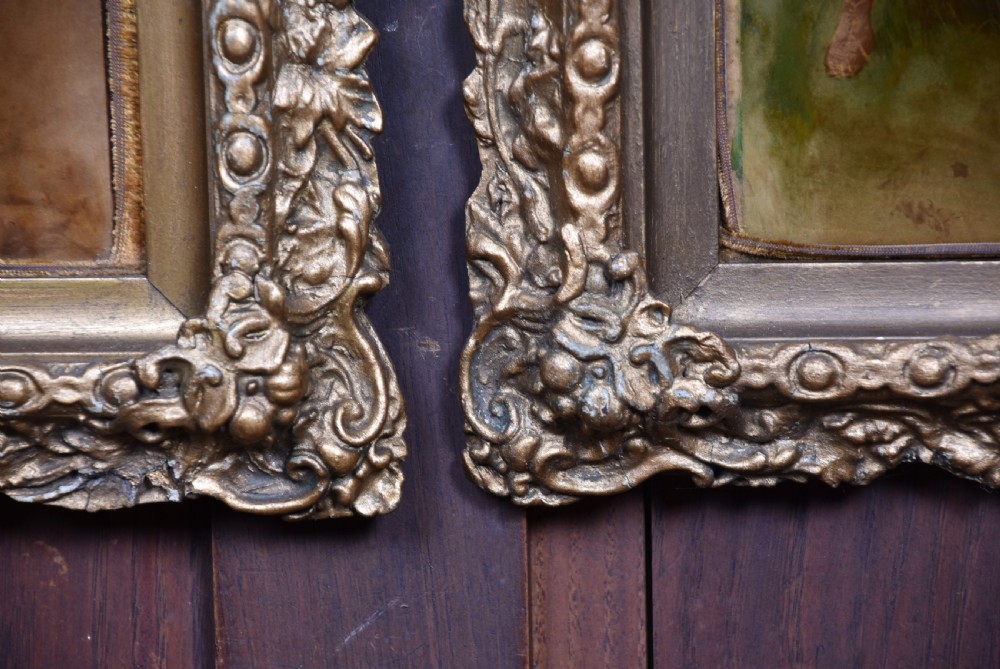 A pair of Victorian glass crystoleum artworks depicting children in countryside scenes, set inside heavy gilded frames. View VIII
