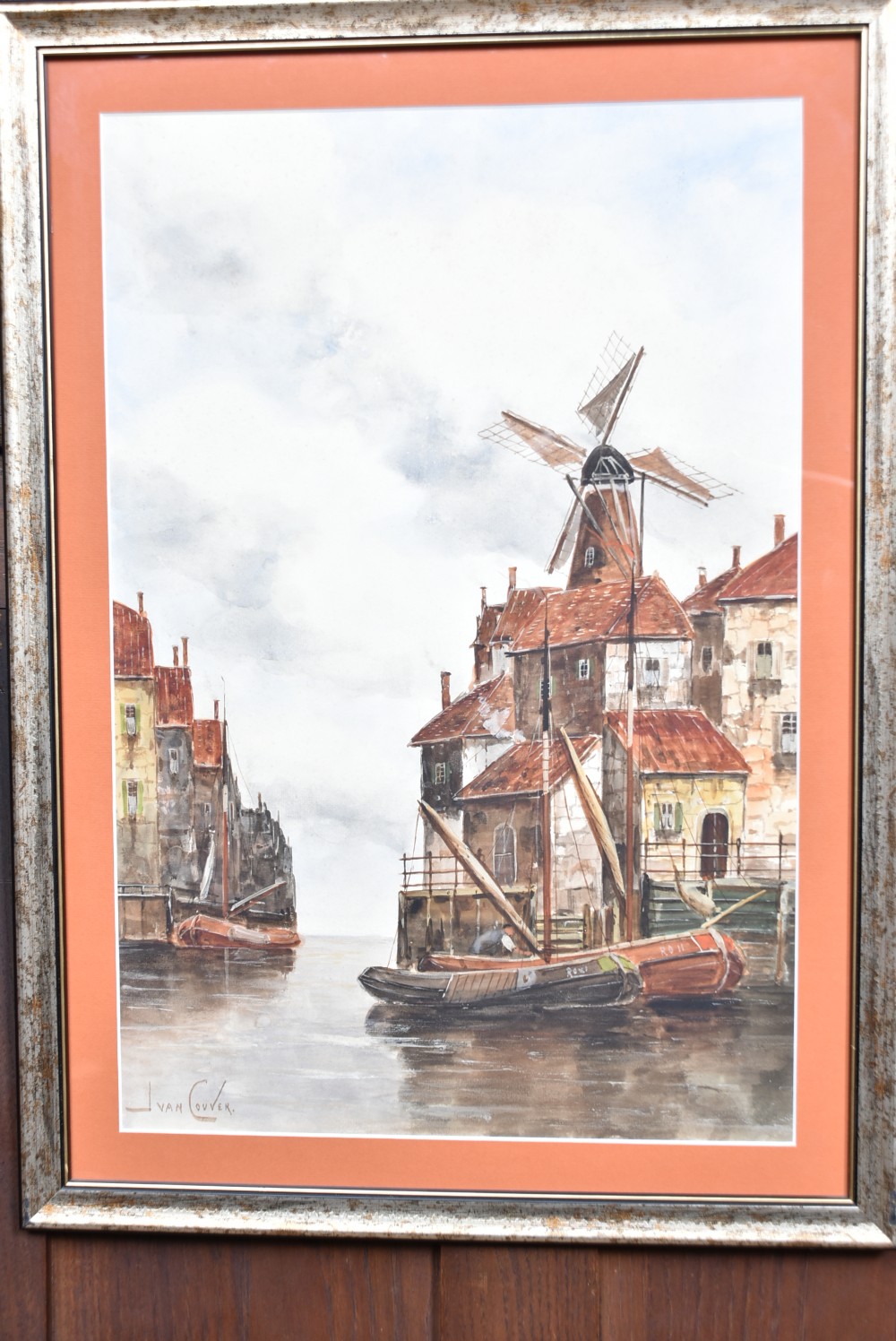 A pair of framed Victorian watercolour paintings depicting Dutch coastal scenes with windmills, boats, and canal buildings, finished with terracotta mounts and silvered frames. View V