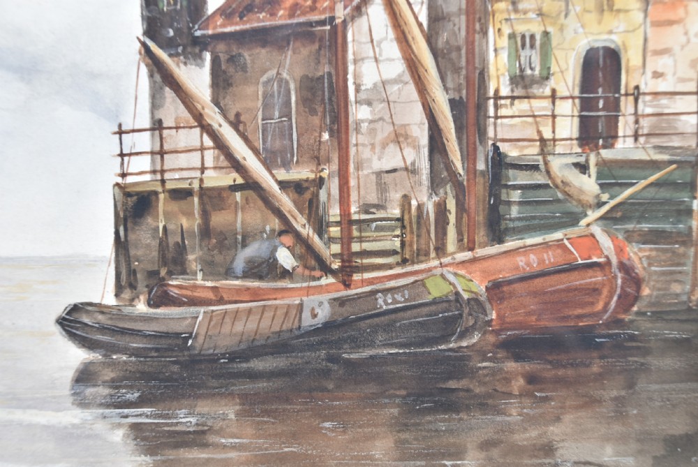 A pair of framed Victorian watercolour paintings depicting Dutch coastal scenes with windmills, boats, and canal buildings, finished with terracotta mounts and silvered frames. View VIII