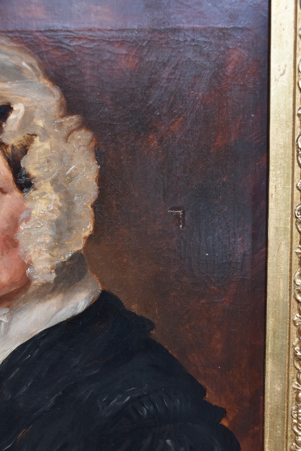 An antique 19th-century oil portrait painting on canvas depicting an elderly woman wearing a lace bonnet, set inside a heavy ornate giltwood frame. View III
