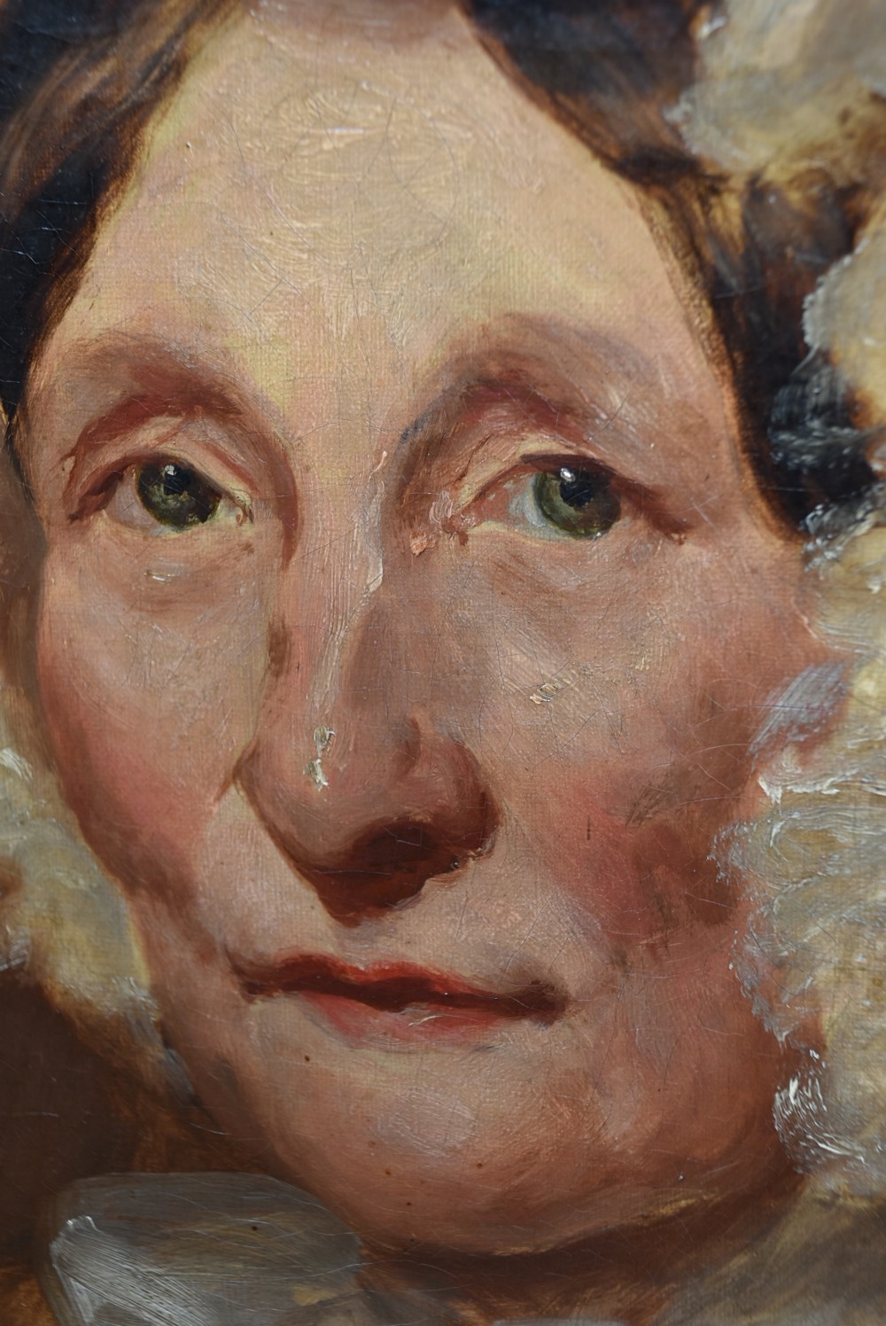 An antique 19th-century oil portrait painting on canvas depicting an elderly woman wearing a lace bonnet, set inside a heavy ornate giltwood frame. View X