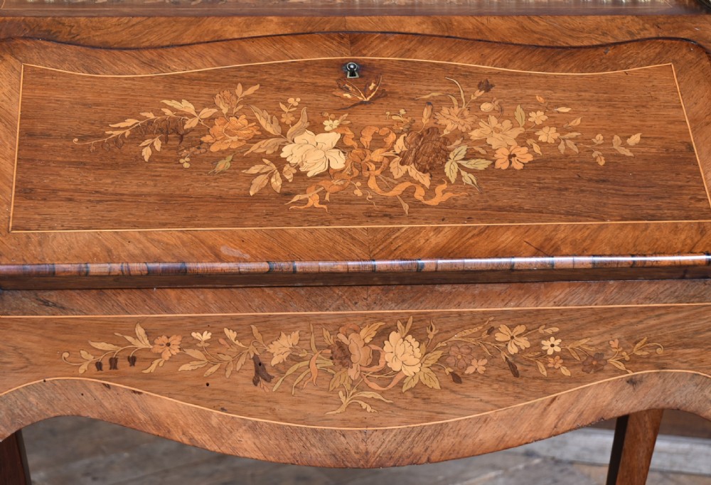 A Victorian marquetry bureau de dame desk featuring floral wood inlays, a slant front writing slope, pierced brass top gallery, and cabriole legs with brass mounts. View III