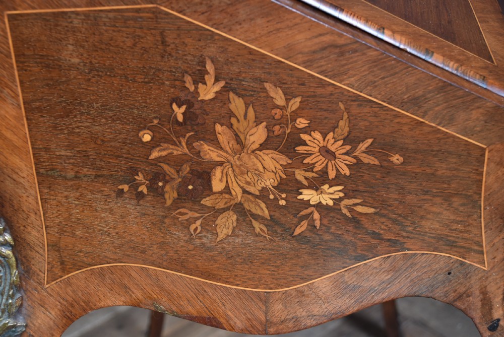 A Victorian marquetry bureau de dame desk featuring floral wood inlays, a slant front writing slope, pierced brass top gallery, and cabriole legs with brass mounts. View XV