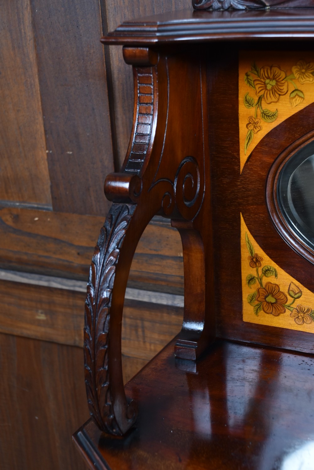 An Edwardian mahogany display cabinet featuring hand-painted floral borders, an oval mirror top section, glazed doors, and cabriole legs. View XIII