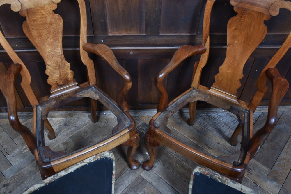 A pair of Victorian walnut armchairs featuring vase-shaped back splats, curved armrests, floral tapestry upholstered seats, and cabriole legs with shell-carved knees. View XVII
