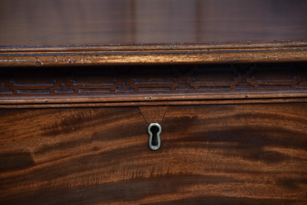 A Georgian style dark mahogany lowboy featuring five drawers with brass handles, a carved apron, and cabriole legs with ball and claw feet. View IX
