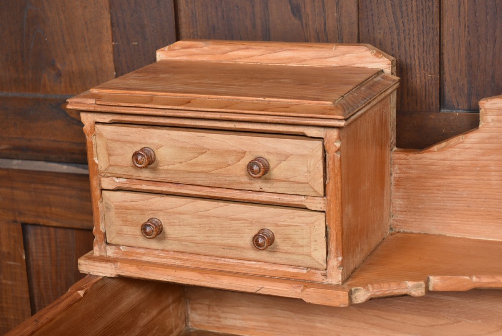 A Scottish Victorian pine kitchen dresser featuring a raised gallery with four small drawers, three upper frieze drawers, and a lower three-door cupboard with diagonal timber panelling. View V