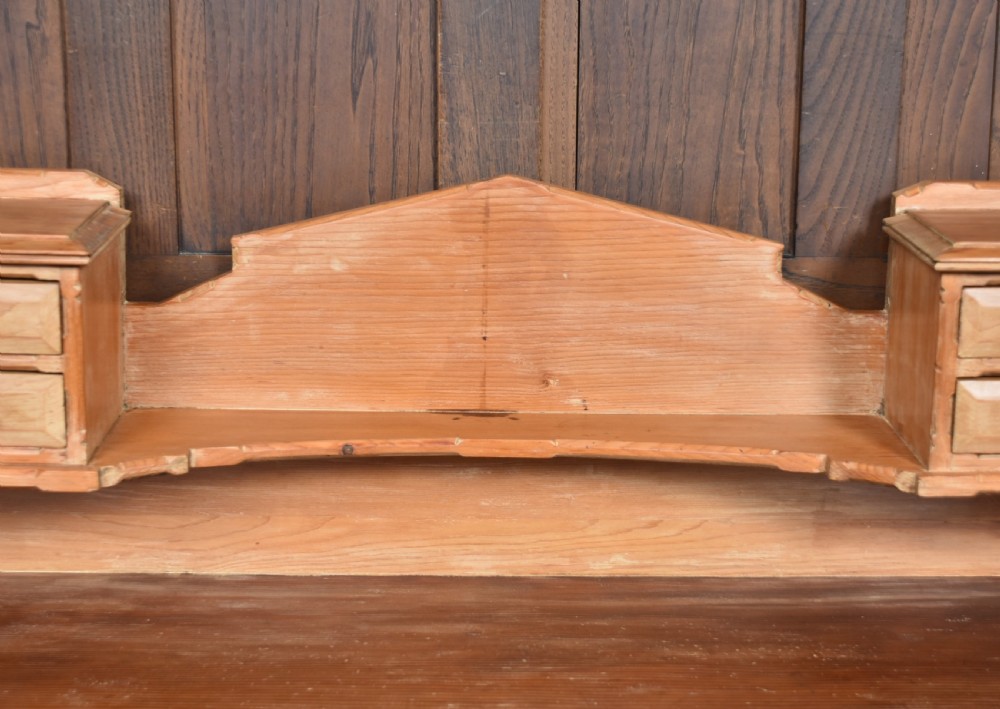 A Scottish Victorian pine kitchen dresser featuring a raised gallery with four small drawers, three upper frieze drawers, and a lower three-door cupboard with diagonal timber panelling. View VI