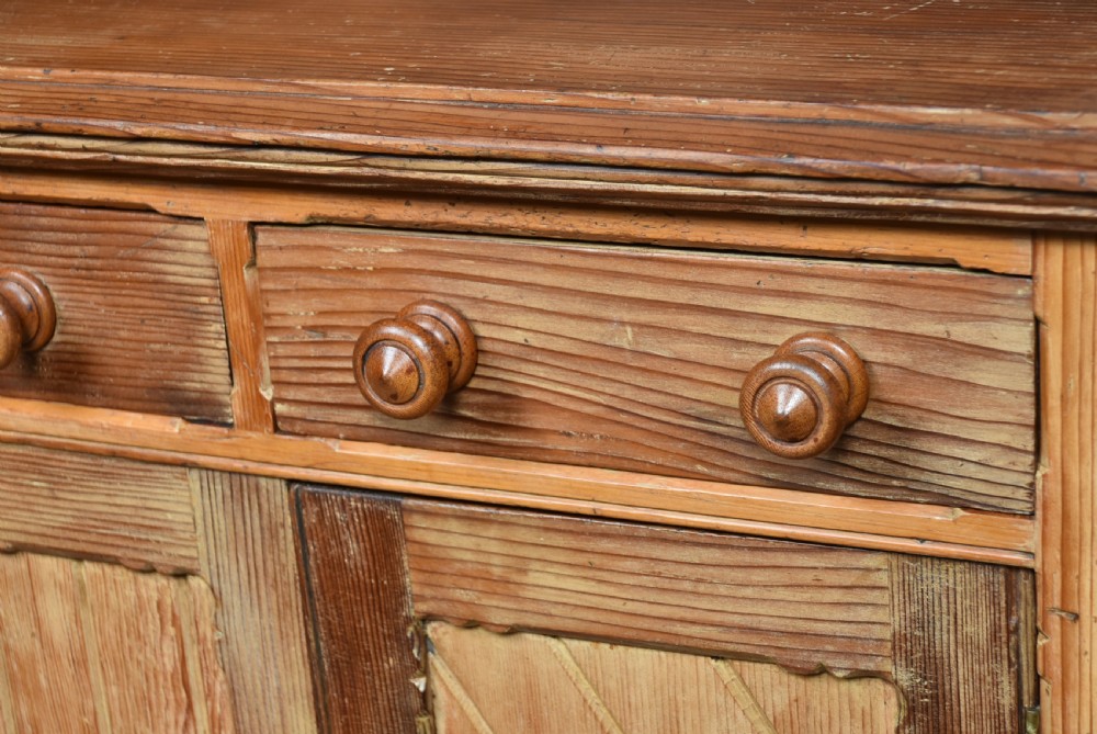 A Scottish Victorian pine kitchen dresser featuring a raised gallery with four small drawers, three upper frieze drawers, and a lower three-door cupboard with diagonal timber panelling. View VIII