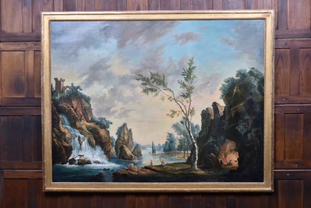 An 18th-century classical landscape oil painting on canvas featuring a waterfall, rocky cliffs, and distant river set within a moulded giltwood frame.