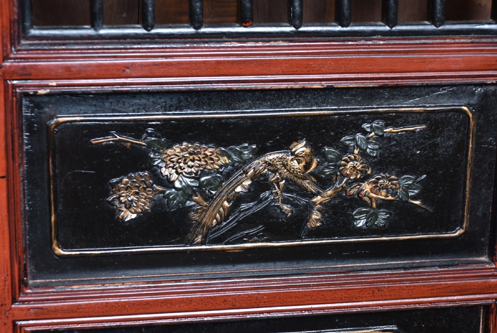 A four-panel tall folding room screen featuring red-lacquered timber framing, intricate black lattice fretwork, and carved gilded lower panels. View XIII
