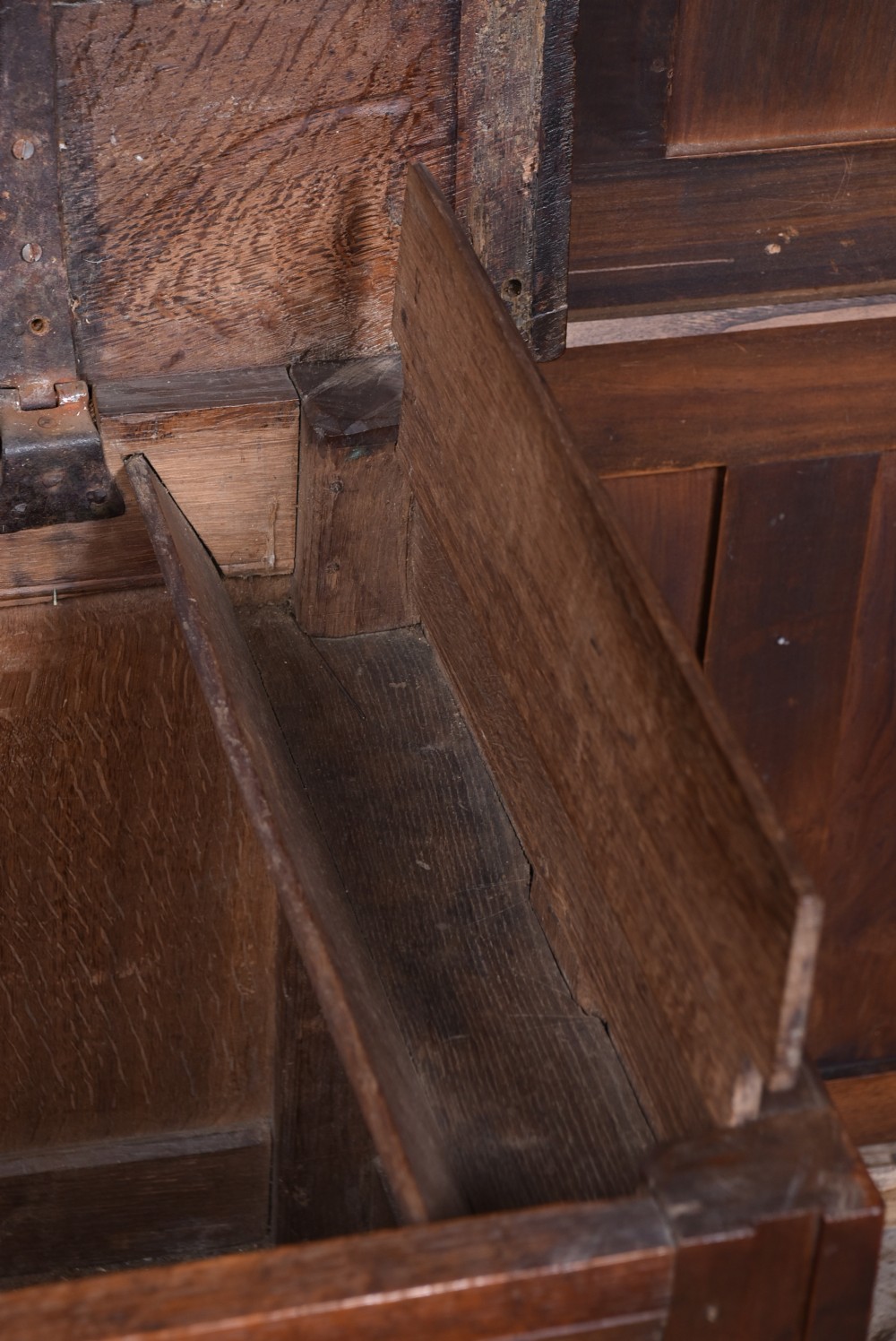 An 18th-century dark oak coffer with a rectangular top lid, three front recessed panels, and a central iron keyhole escutcheon. View VII