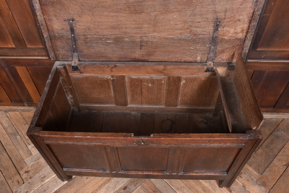 An 18th-century dark oak coffer with a rectangular top lid, three front recessed panels, and a central iron keyhole escutcheon. View VIII