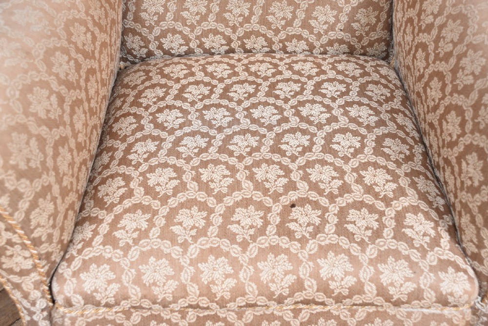A 19th-century wingback armchair upholstered in patterned beige fabric, supported on front cabriole legs with pad feet. View IX