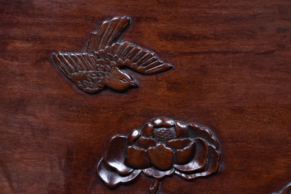 A dark brown carved Chinese hardwood table screen featuring relief-carved phoenix and floral motifs on a central panel set into a stand with openwork fretwork. View VIII