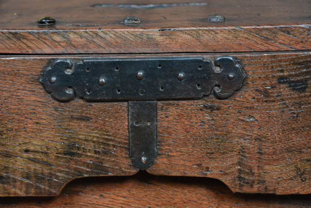 A heavy Japanese dark wooden zenibako money box reinforced with iron studs and featuring a top coin slot. View XIII