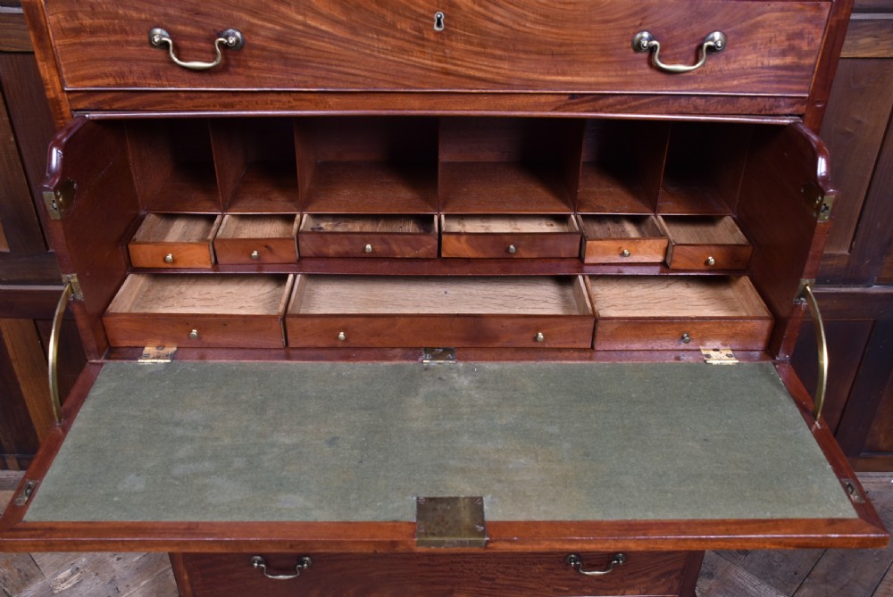 A tall Georgian mahogany secretaire chest featuring six graduated drawers, brass swan-neck handles, and ogee bracket feet. View XII