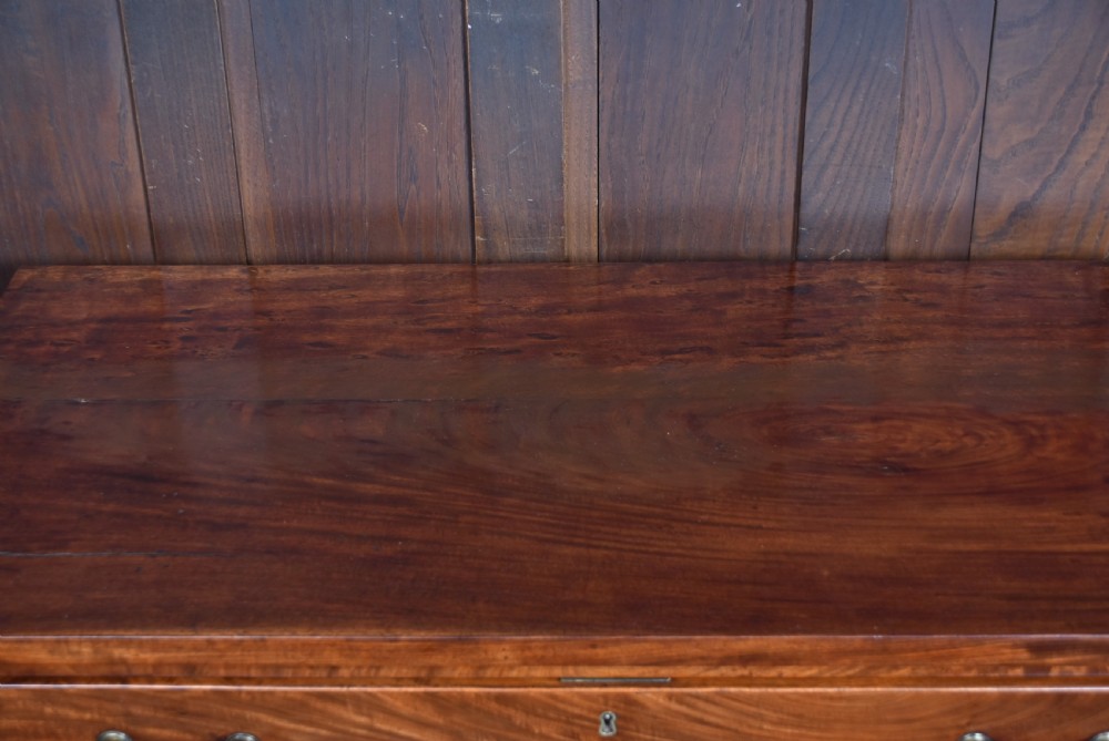 A tall Georgian mahogany secretaire chest featuring six graduated drawers, brass swan-neck handles, and ogee bracket feet. View XV
