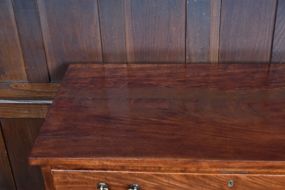 A tall Georgian mahogany secretaire chest featuring six graduated drawers, brass swan-neck handles, and ogee bracket feet. View XVI