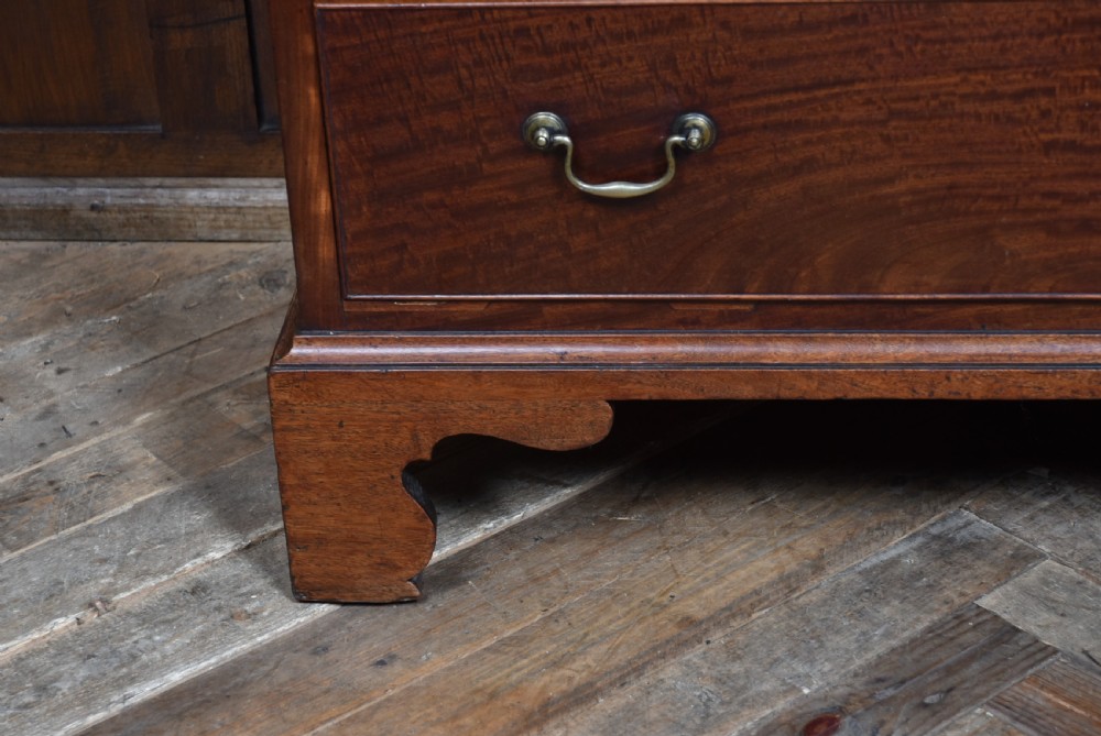A tall Georgian mahogany secretaire chest featuring six graduated drawers, brass swan-neck handles, and ogee bracket feet. View XVII