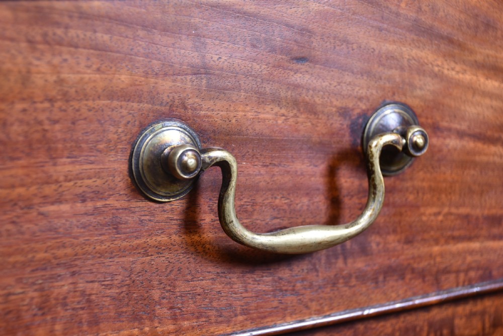 A tall Georgian mahogany secretaire chest featuring six graduated drawers, brass swan-neck handles, and ogee bracket feet. View XIX