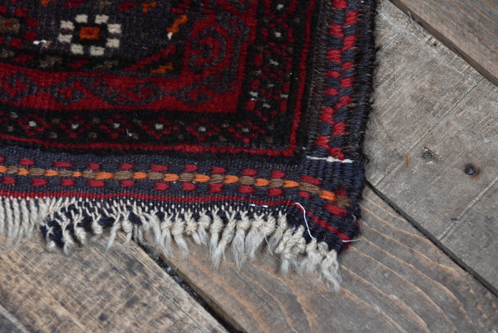 A handwoven vintage Iranian rug featuring a light brown central field decorated with animal and bird motifs framed by dark red geometric borders. View VI