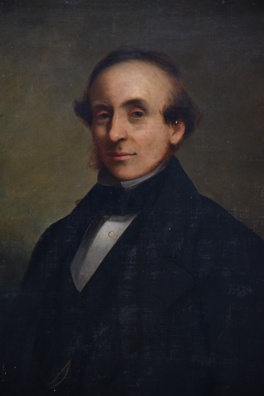 A nineteenth-century oil painting depicting a gentleman in dark formal wear within a carved gilded frame. View III