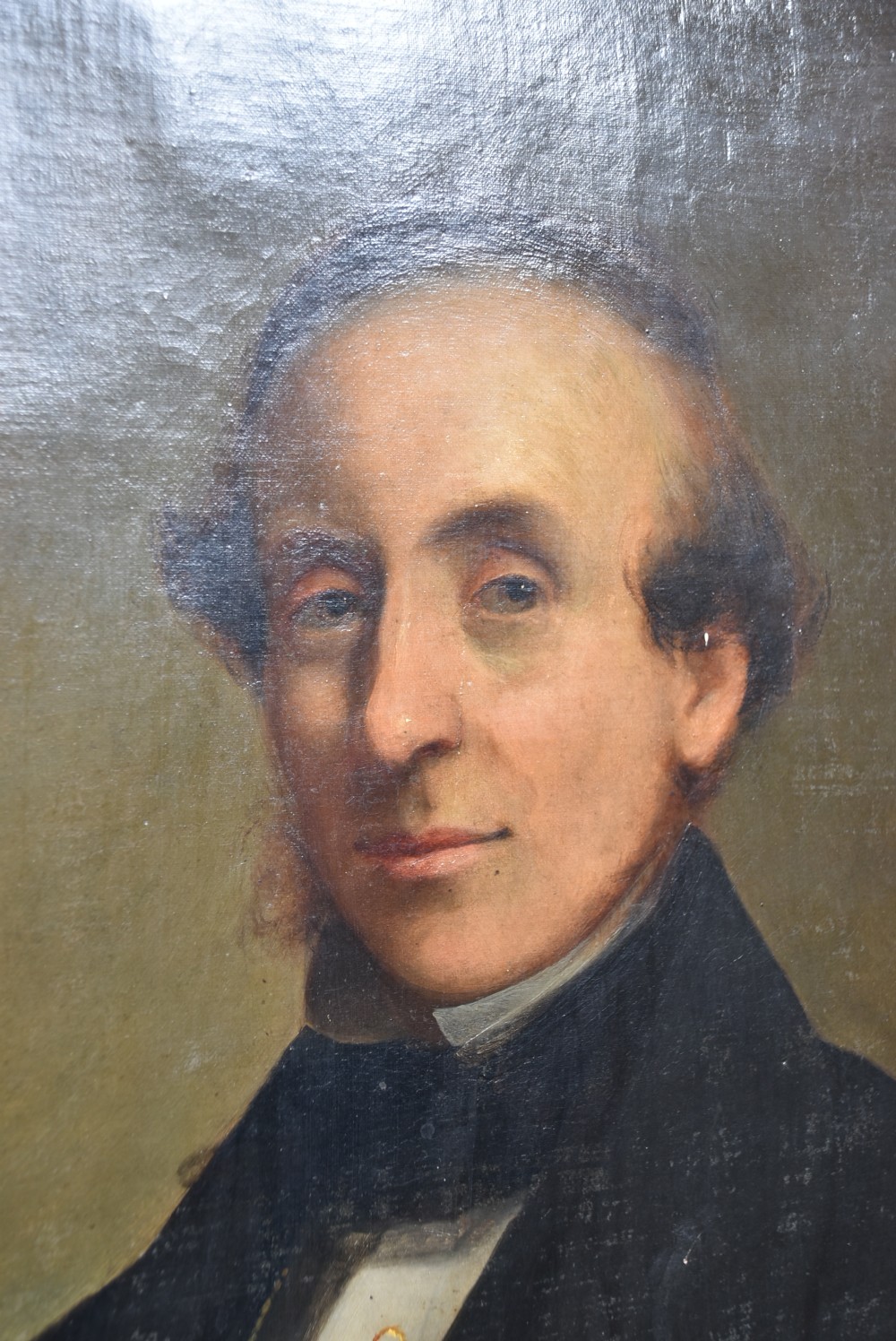 A nineteenth-century oil painting depicting a gentleman in dark formal wear within a carved gilded frame. View V