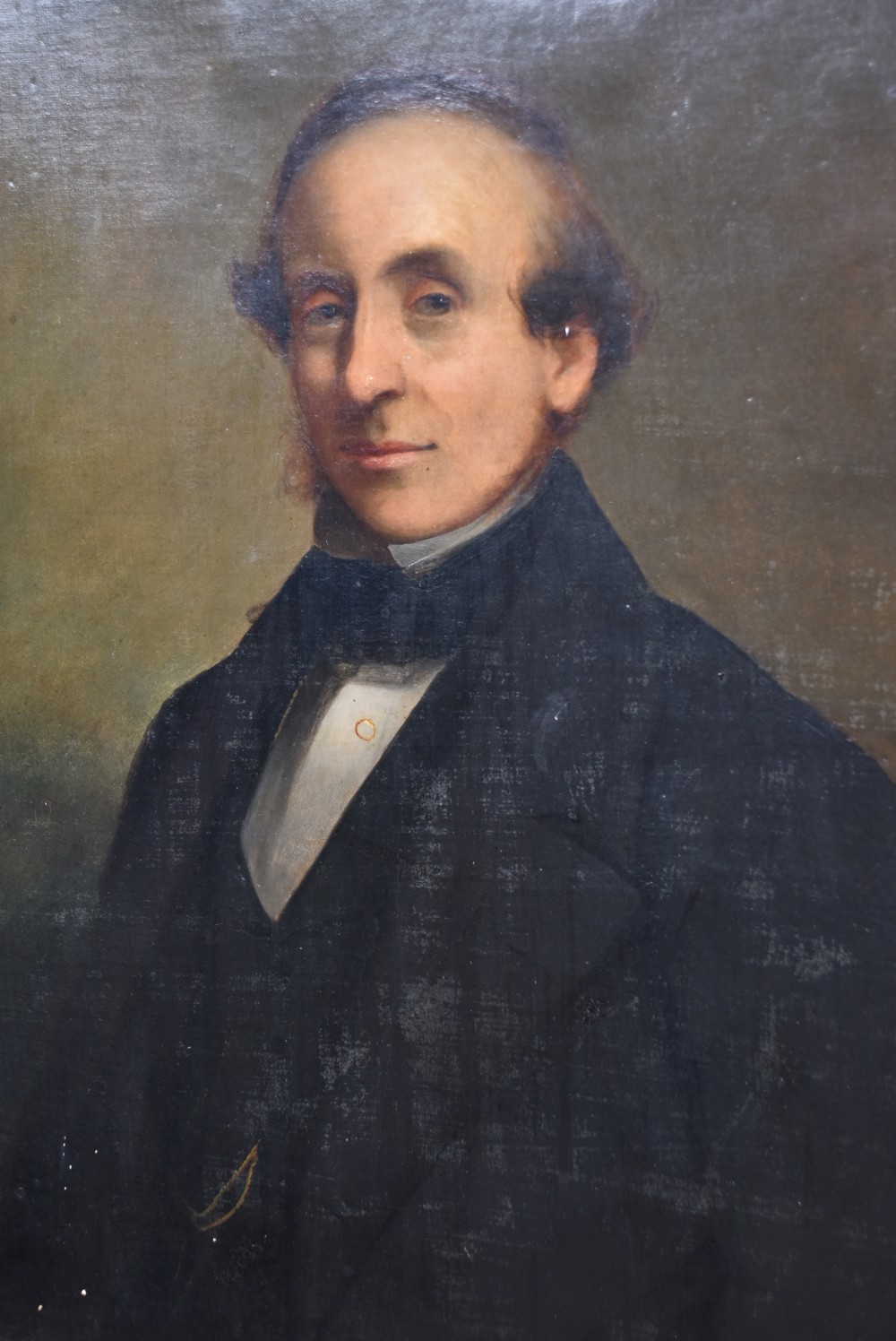 A nineteenth-century oil painting depicting a gentleman in dark formal wear within a carved gilded frame. View XII