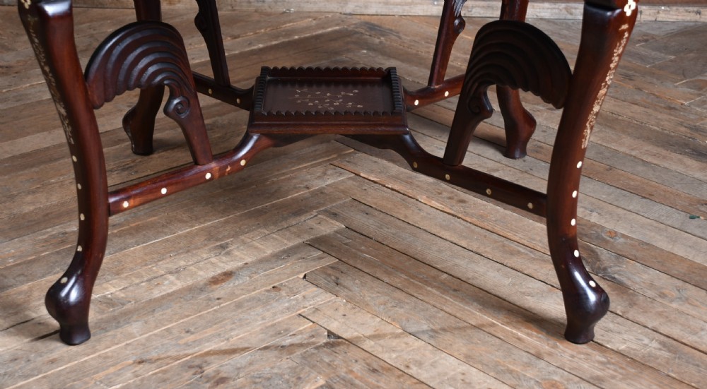 A circular dark hardwood centre table featuring intricate mother-of-pearl floral inlays, carved cabriole legs, and a grey and white variegated marble inset top. View IX