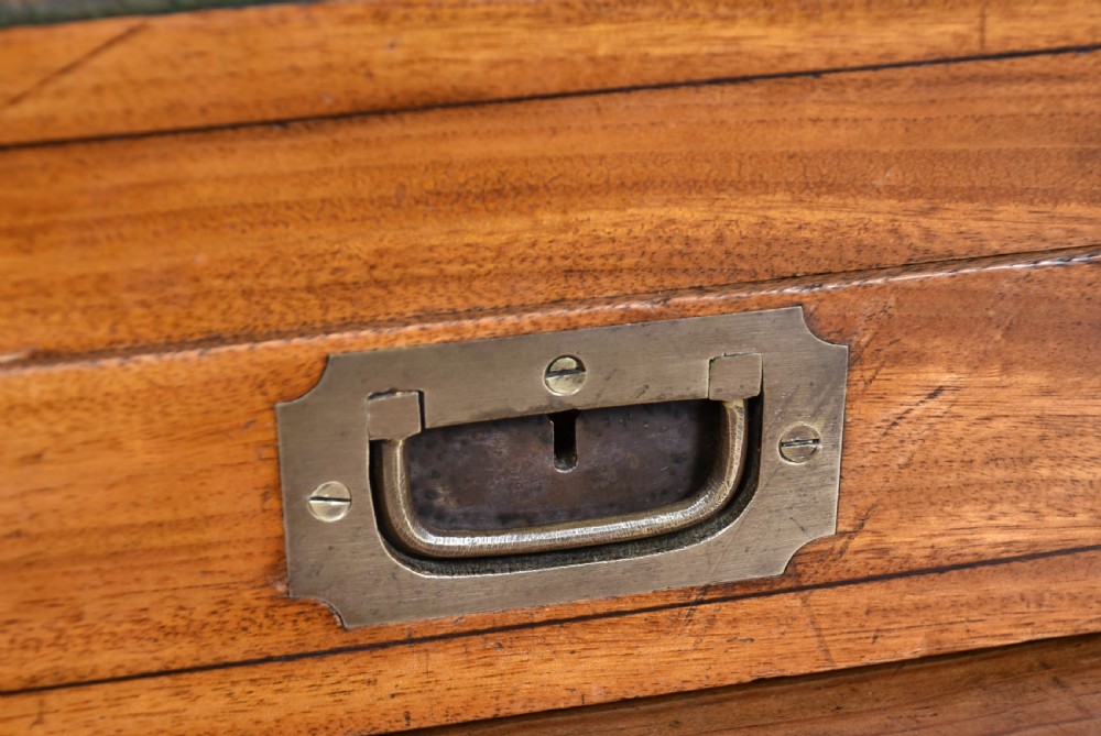 A nineteenth-century camphor wood roll-top writing box with brass-bound corners, a central brass cartouche, and a slatted tambour top. View VII