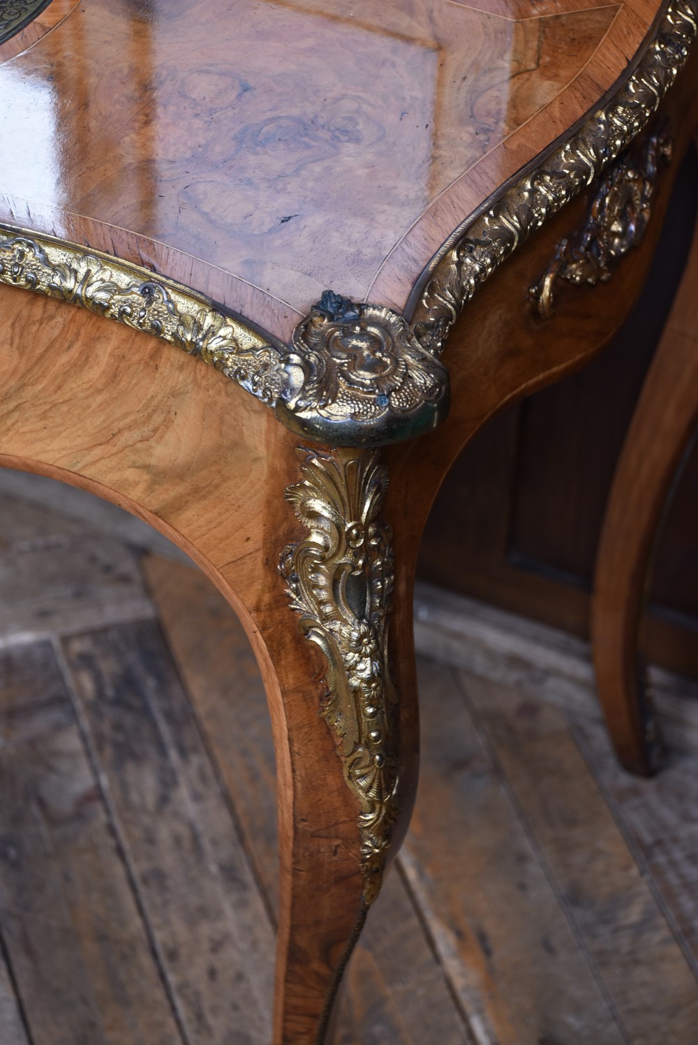 Victorian burr walnut writing desk featuring cabriole legs, brass mounts, an inset leather writing top, and an upper superstructure with glazed side cabinets and a central mirror. View XVI