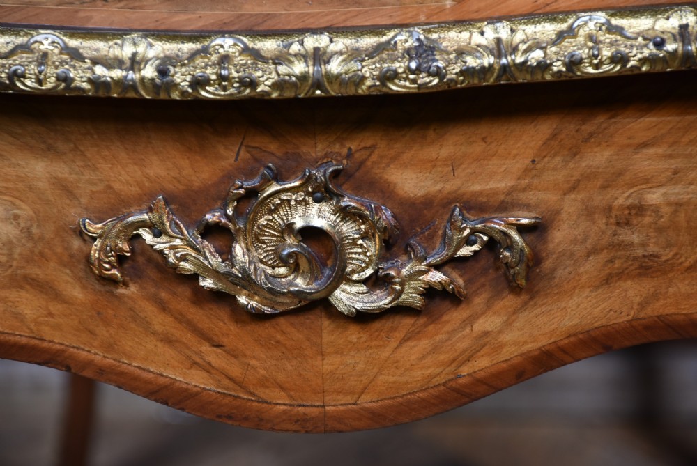 Victorian burr walnut writing desk featuring cabriole legs, brass mounts, an inset leather writing top, and an upper superstructure with glazed side cabinets and a central mirror. View XIX