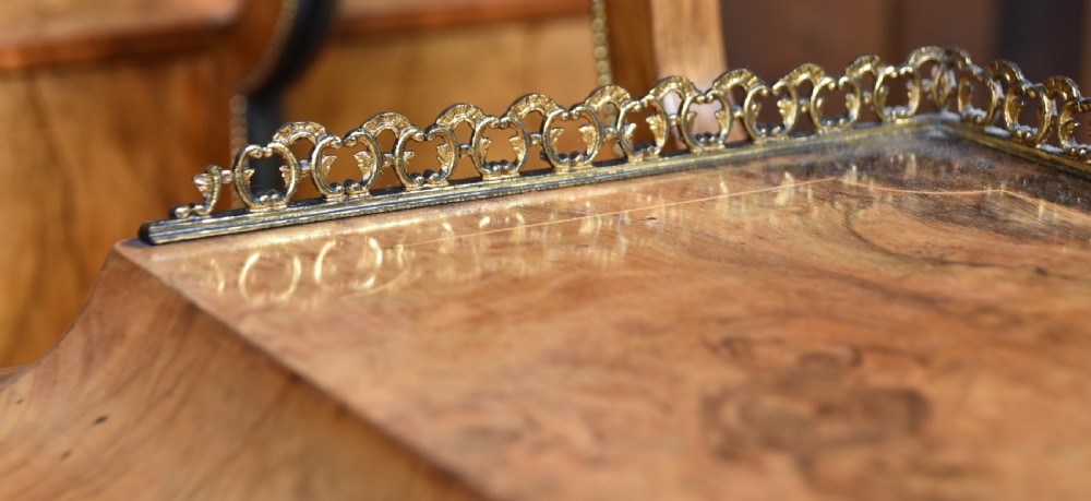 Victorian burr walnut writing desk featuring cabriole legs, brass mounts, an inset leather writing top, and an upper superstructure with glazed side cabinets and a central mirror. View XX