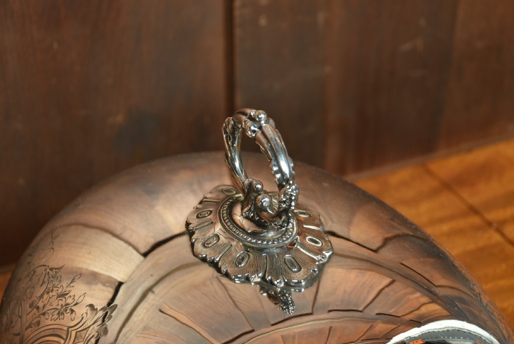 A pair of domed silver-plated meat covers featuring ornate cast handles, beaded lower rims, and engraved foliate cartouches. View XI