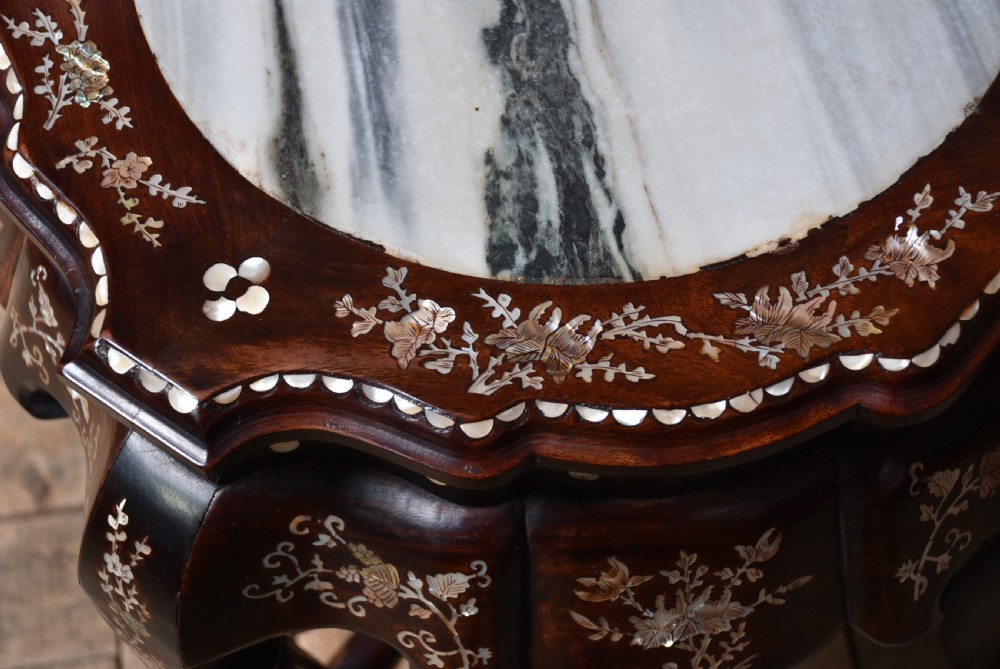A pair of low Chinese dark hardwood plant stands featuring circular inset marble tops, Mother-of-Pearl floral inlay along the scalloped aprons, and carved cabriole legs. View XI