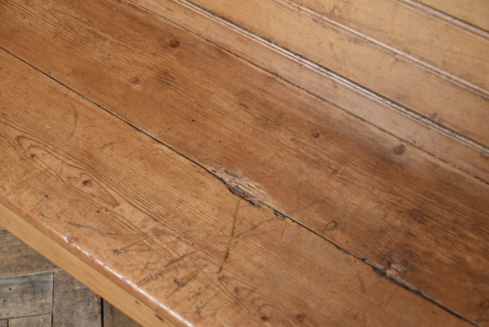 A high-backed antique pine tavern bench featuring horizontal panelled construction and shaped side supports. View VIII