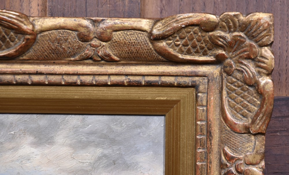 An impressionist oil painting depicting figures casting off in a rowing boat from a rocky shore, housed in an ornate carved gold gilt frame. View III