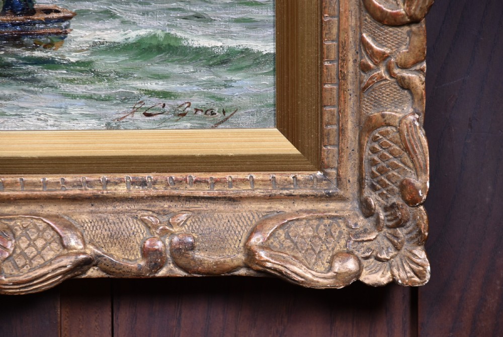 An impressionist oil painting depicting figures casting off in a rowing boat from a rocky shore, housed in an ornate carved gold gilt frame. View IV