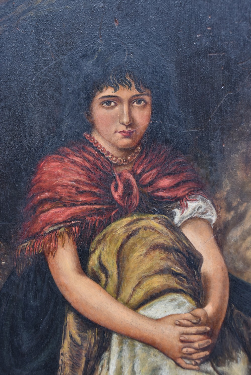 A late nineteenth-century oil painting on a bevelled wooden panel depicting a barefoot young woman wearing a red shawl. View VI
