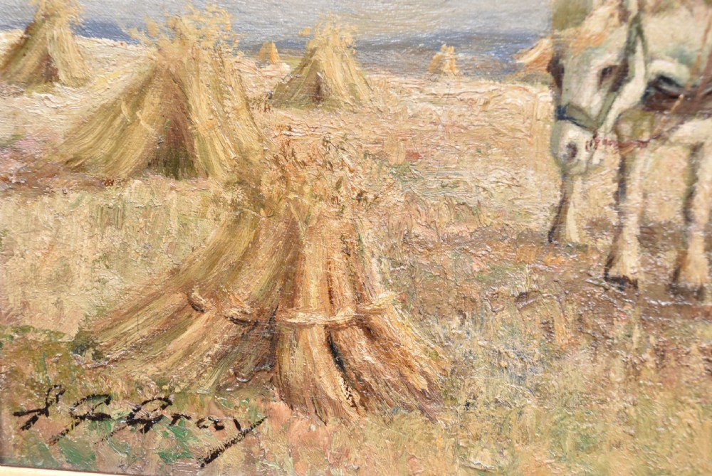 An oil painting set within a moulded gilt frame depicting farm workers and heavy horses gathering hay stooks in an open field under a cloudy sky. View IV