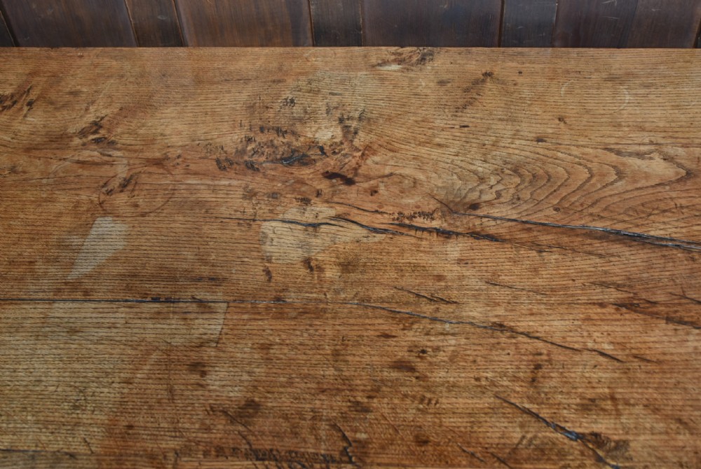 An 18th-century solid oak refectory table featuring a plank top and carved bulbous cup-and-cover turned legs resting on a stretcher base. View VIII