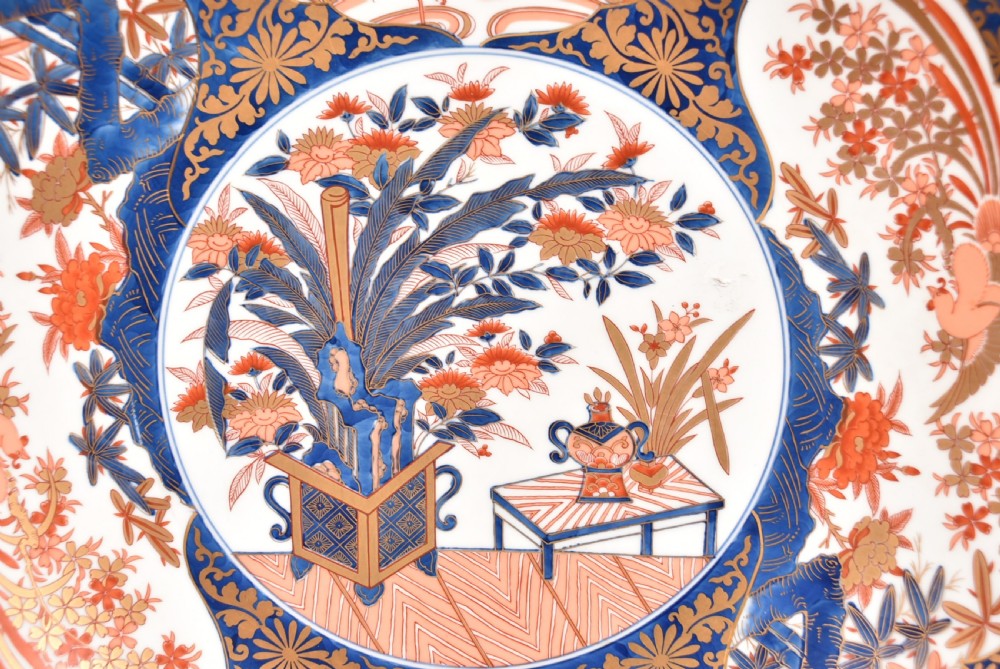 A large round Japanese Imari porcelain charger decorated with vibrant cobalt blue, terracotta red, and gilded floral and bird motifs. View II