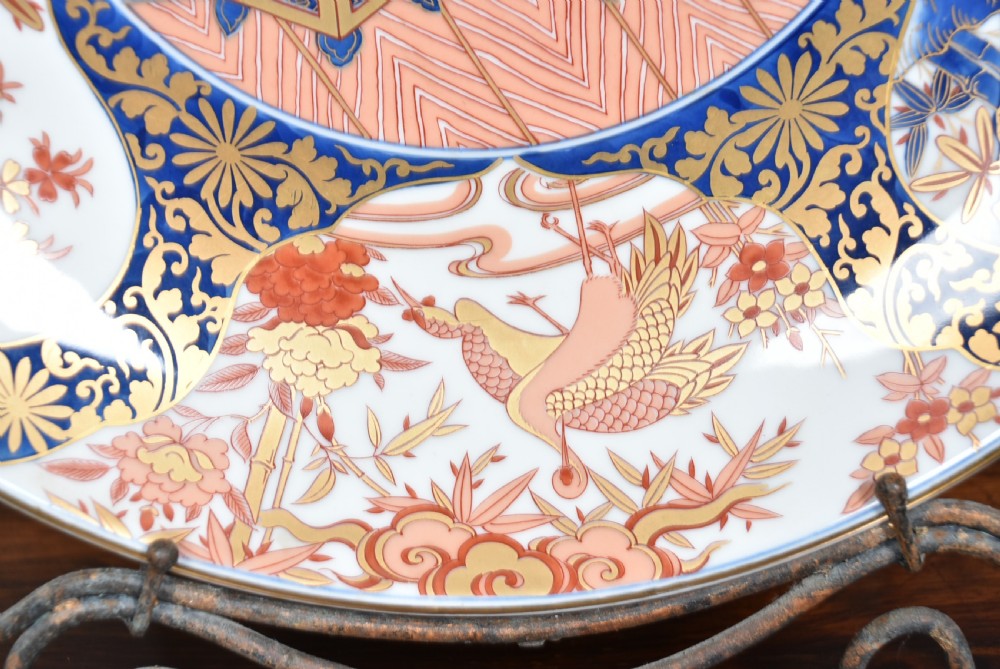 A large round Japanese Imari porcelain charger decorated with vibrant cobalt blue, terracotta red, and gilded floral and bird motifs. View VII